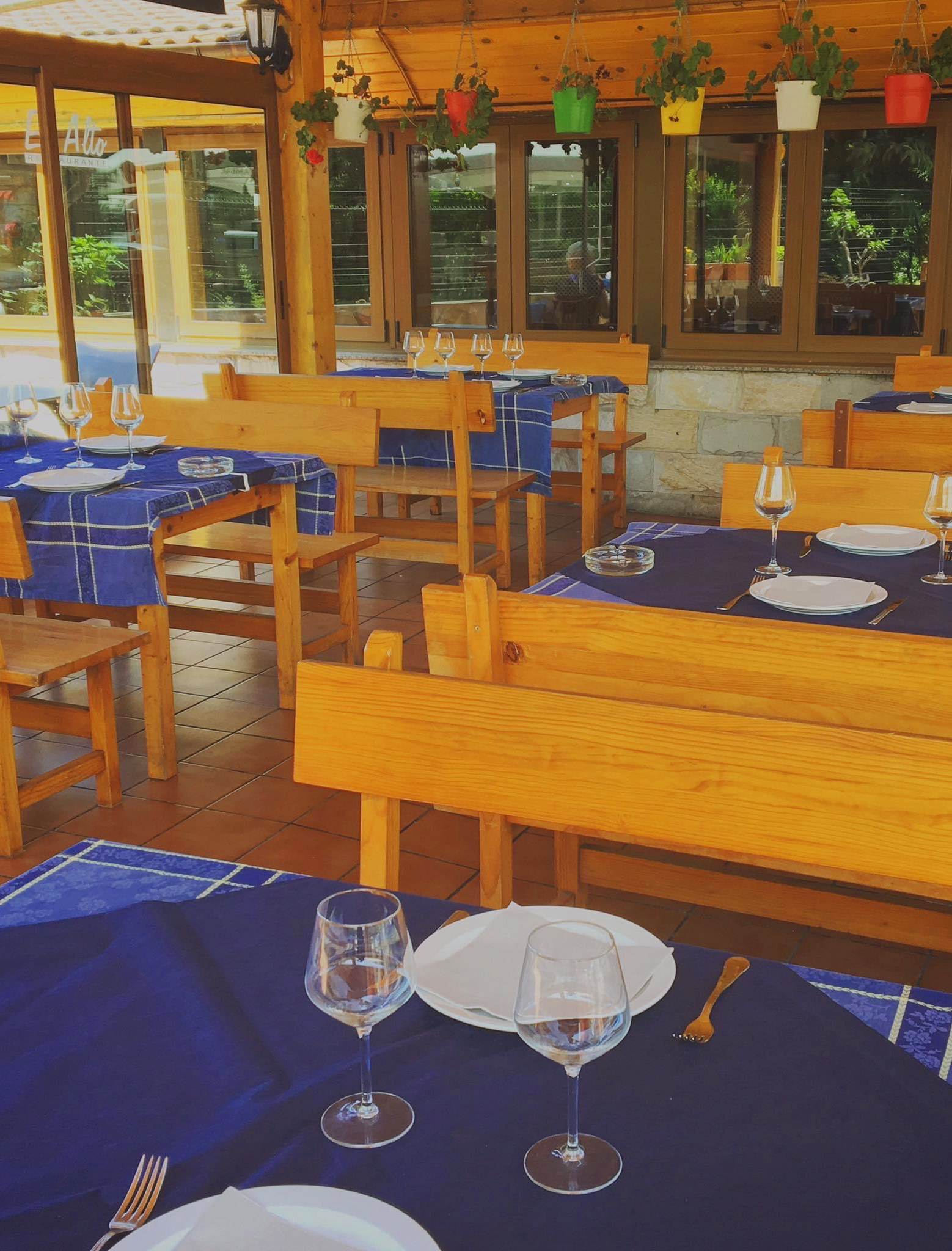Interior del restaurante con mesas y sillas de madera